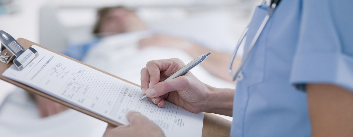 Image: nurse making notes about an ultrasound diagnostic scan.
