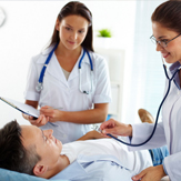 Image: GPs examining a patient prior to an ultrasound diagnostic scan.